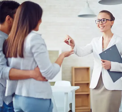 A woman is shaking hands with two people.